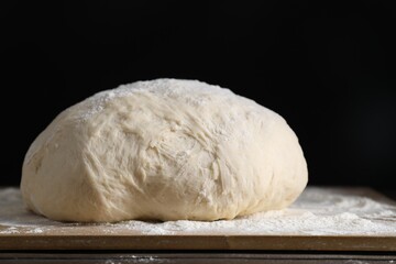 Raw homemade dough on wooden table, closeup