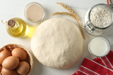 Raw dough and ingredients on white marble table, flat lay