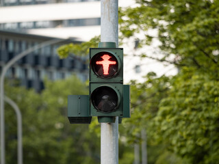 Pedestrian traffic light in Germany. Red stoplight icon at an intersection. Crossing the road is...