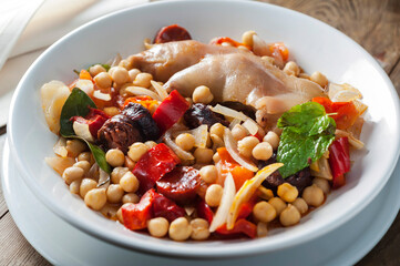 pork feet stew with vegetables, bacon and chick peas