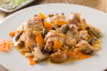 Rabbit stew with almonds, carrots, onions and mushrooms