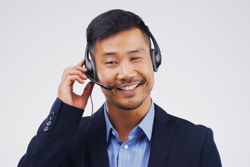 Listening, thinking and Asian man in callcenter with smile, headset and happy in studio. Male...