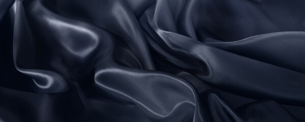 A closeup of black blue satin fabric with a beautiful pattern