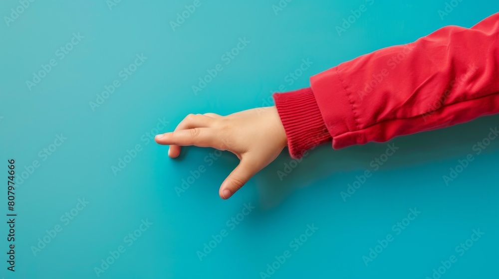 Wall mural A child's hand reaching out to touch a blue wall, AI