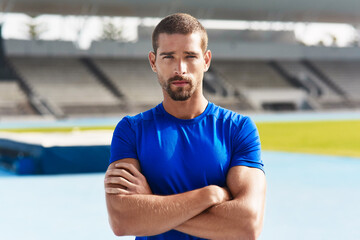 Portrait, confident man and athlete at stadium for fitness, wellness or exercise for body health in...