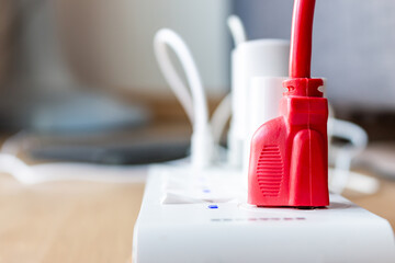 Red electrical plug, white electrical plug isolated on background.