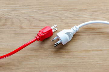 Red electrical plug, white electrical plug isolated on background.