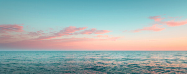 A serene ocean scene captured at sunset, where the sky and water meet in a harmonious blend of pastel pinks and blues, evoking a tranquil and picturesque setting.