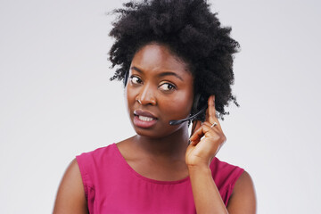 Black woman, talking or listening with headset in studio background for consultant, call centre or...