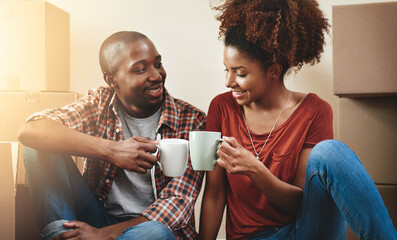 Black couple, cheers and coffee on floor of new house with bonding, support and happy for break...