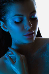 Womans profile glows with sparkling skin, highlighted by blue tones makeup, exuding a calm and...