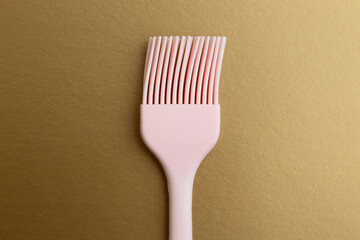 Pink Silicone Basting Brush on a Golden Background