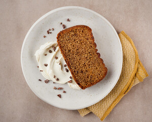 Ginger loaf cake and slices on light surface with empty space for text, top view.