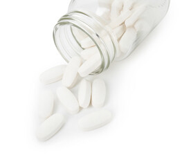 Scattered vitamin pills and bottle isolated on white