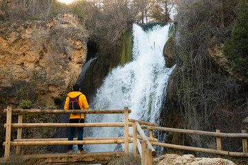 Hiker contemplating the Batida Waterfall in the Sierra de Albarracin.