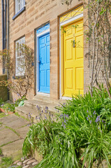 Two front doors with vontratsing colors blue and yellow