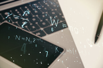 Double exposure of creative scientific formula concept on laptop background, research and...