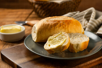 French bread in the basket with butter and rustic background