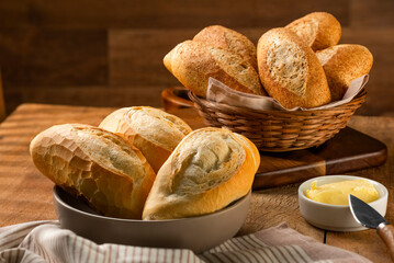 French bread in the basket with butter and rustic background