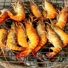 Grilled prawns on charcoal grill, culinary delight at street food market, exemplifying global trend of enjoying fresh, locally sourced seafood in casual settings. Healthy food. Square format