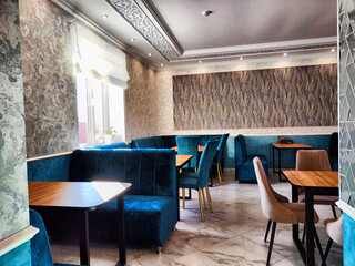 Elegant Restaurant Interior With Plush Seating and Natural Light. A cozy and stylish dining area...