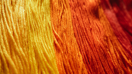 Threads of red and yellow shades in close-up.