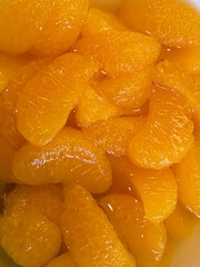 Close up of mandarin orange slices in juice