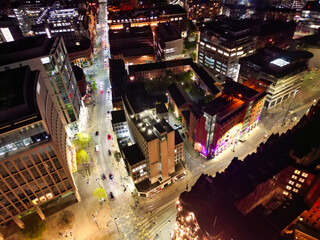 Aerial Night View of Illuminated Central Manchester City and Downtown Buildings, England United...
