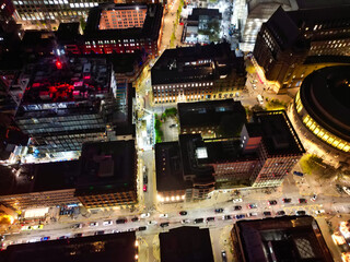 Aerial Night View of Illuminated Central Manchester City and Downtown Buildings, England United...