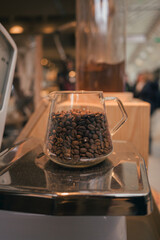 Weighing fresh roasted coffee beans on a scale at a local marketplace