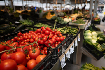 Fresh tomatoes and vegetables on display at porto market during daytime