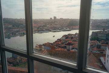 Panoramic view of Douro river and Porto skyline at dusk through a window