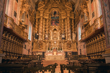 Majestic golden altarpiece of Porto cathedral in warm ambient light