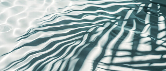 Palm Fronds Cast Shadows on Rippling Water Surface. Abstract Textured Background of Light and Shadow. Palm Leaves and Rippling Water. 