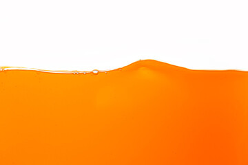 Orange juice texture, close-up, macro, isolated white background,Close up bright orange juice...