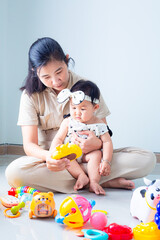 mother and child playing with toys,Portrait of asian little cute girl playing colorful blocks with her mother over white background. Learning by playing education home school concept. Mother