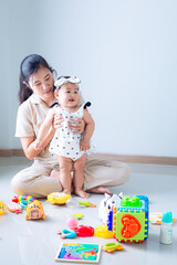 mother and child playing with toys,Portrait of asian little cute girl playing colorful blocks with her mother over white background. Learning by playing education home school concept. Mother