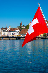 Swiss Flag in City of Lucerne with Lake in a Sunny Summer Day in Lucerne, Switzerland.