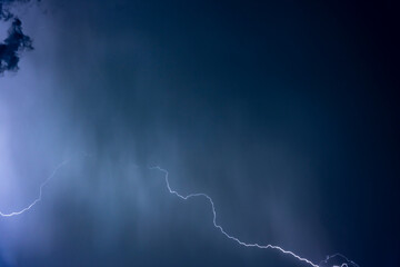 Naklejka premium Beautiful Lightning Strikes and Clouds at Night in Lugano, Ticino, Switzerland.