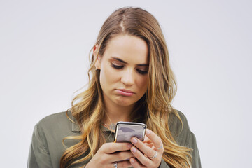 Woman, depression and sad with smartphone for social media post in grey background, technology and...