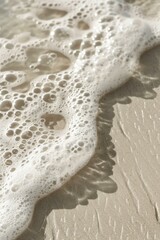 detail of ivory sand and coming wave, minimalist