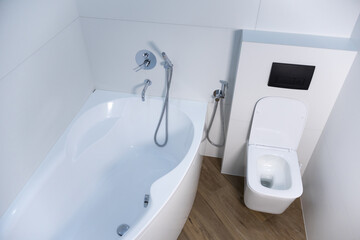 Modern bathroom and toilet in white and black colours with shower bidet.