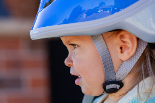 Toddler wearing bike helmet clicked up for safety