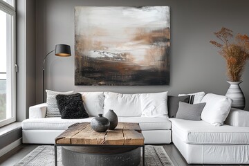 Minimalist interior design of modern living room with white sofa and wooden coffee table near abstract painting on wall