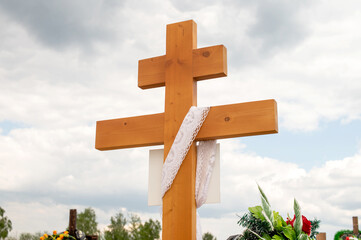 Wooden cross with white lace cloth. Religious symbol and faith concept.