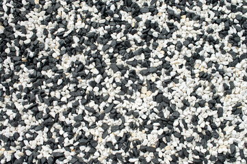 Top view of the decorative natural colorful gravel on the grave. Close-up of the stones.