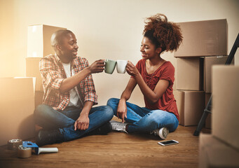 Black couple, cheers and cup on floor of new house with bonding, support and happy for coffee break...