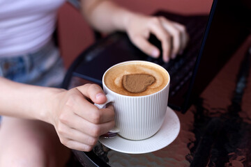 Laptop Work Break with a Heart-Shaped Coffee Foam