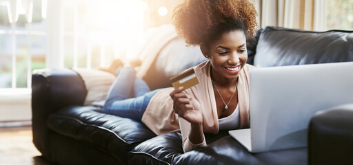 Credit card, laptop and black woman on sofa in home for online shopping, internet purchase and...