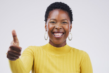 Portrait, smile and black woman with thumbs up in studio for vote, voice or opinion choice on white...